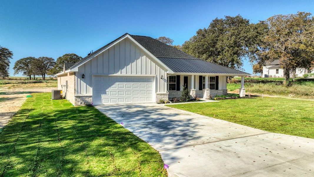 Front exterior of a new home in , Poolville, TX, highlighting curb appeal (Image 2).