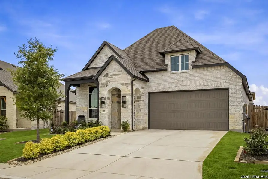 Front exterior of a new home in Alsatian Oaks, Castroville, TX, highlighting curb appeal (Image 2). Front exterior of a new home in Alsatian Oaks, Castroville, TX, highlighting curb appeal (Image 2).