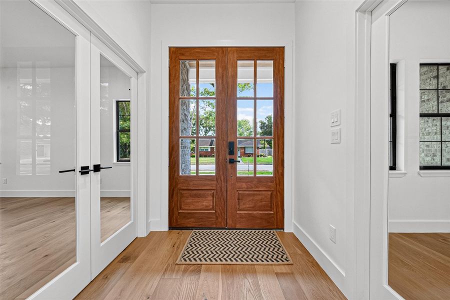 Welcoming entry way with cedar double door. Welcoming entry way with cedar double door.