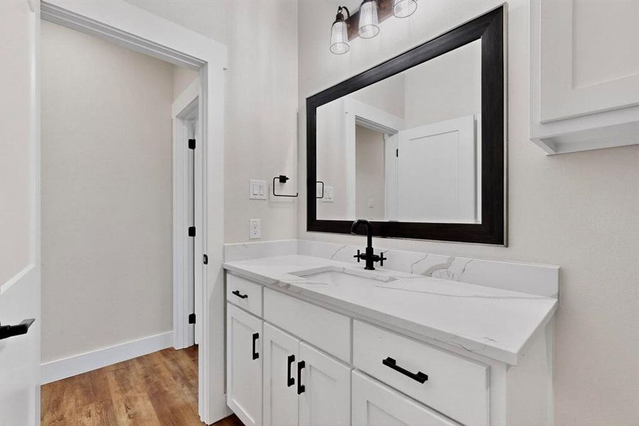 Bathroom featuring light wood-style flooring and vanity