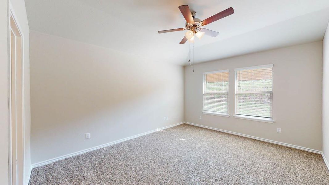 Spare room with carpet, a ceiling fan, and lofted ceiling