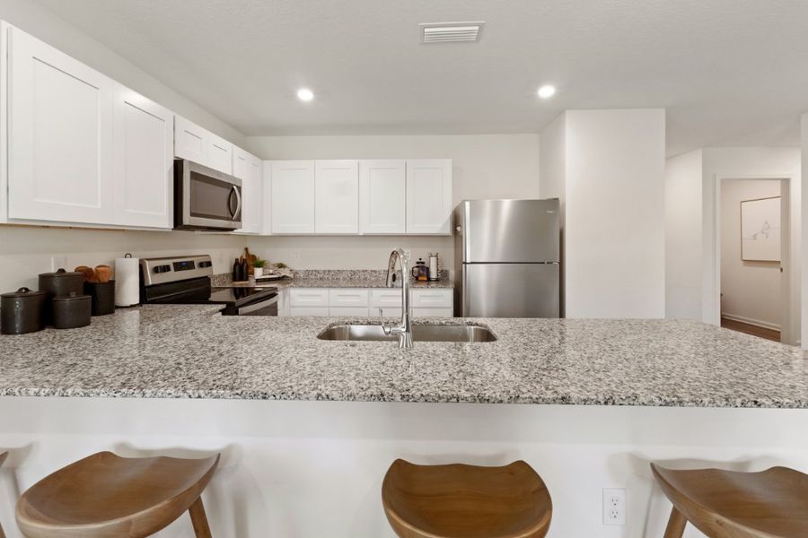 A kitchen with white cabinets. A kitchen with white cabinets.