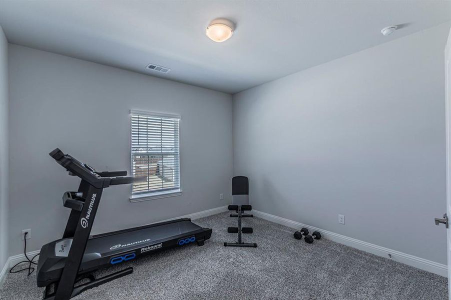 Workout room featuring carpet flooring and baseboards Workout room featuring carpet flooring and baseboards