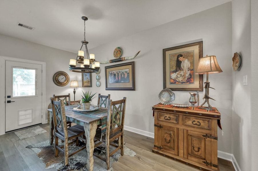Dedicated dining area offers an inviting space for everyday meals and special gatherings, featuring stylish lighting, abundant natural light, and convenient access to the kitchen and backyard. Dedicated dining area offers an inviting space for everyday meals and special gatherings, featuring stylish lighting, abundant natural light, and convenient access to the kitchen and backyard.
