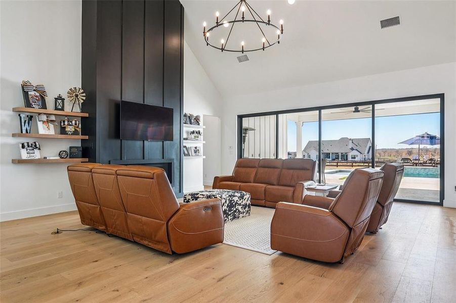 Lovely living room that overlooks the 4 panel sliding door that opens to the outside pool area