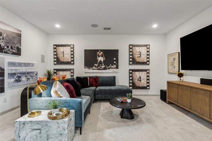 The grand media room adjacent to the light filled game room create the ultimate family entertainment area.