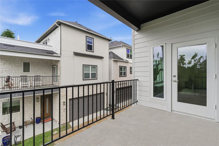 A private balcony extends the primary suite, offering a quiet outdoor retreat.
