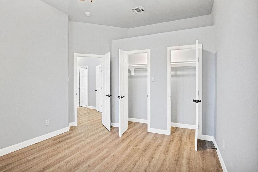 Spare bedroom with ample closet space, ceiling fan and high ceilings!