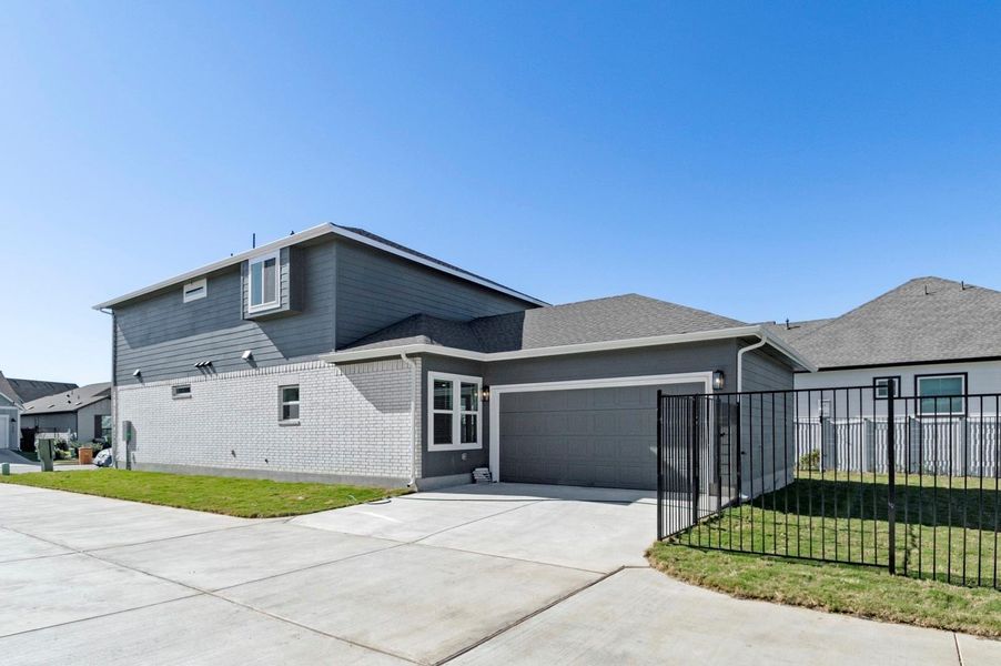 View of front of property featuring brick siding, a garage, concrete driveway, and roof with shingles View of front of property featuring brick siding, a garage, concrete driveway, and roof with shingles