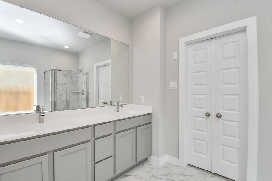 Elevate your daily routine at the elegant vanity, now equipped with double sinks, light countertops, modern hardware, and beautiful recessed lights. Elevate your daily routine at the elegant vanity, now equipped with double sinks, light countertops, modern hardware, and beautiful recessed lights.