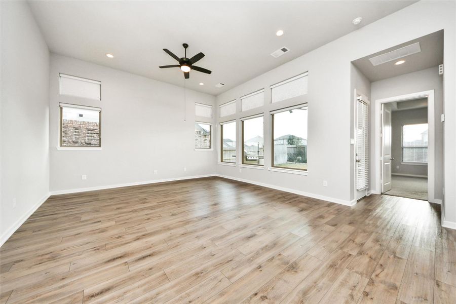 Bright living space overlooking backyard through large windows
