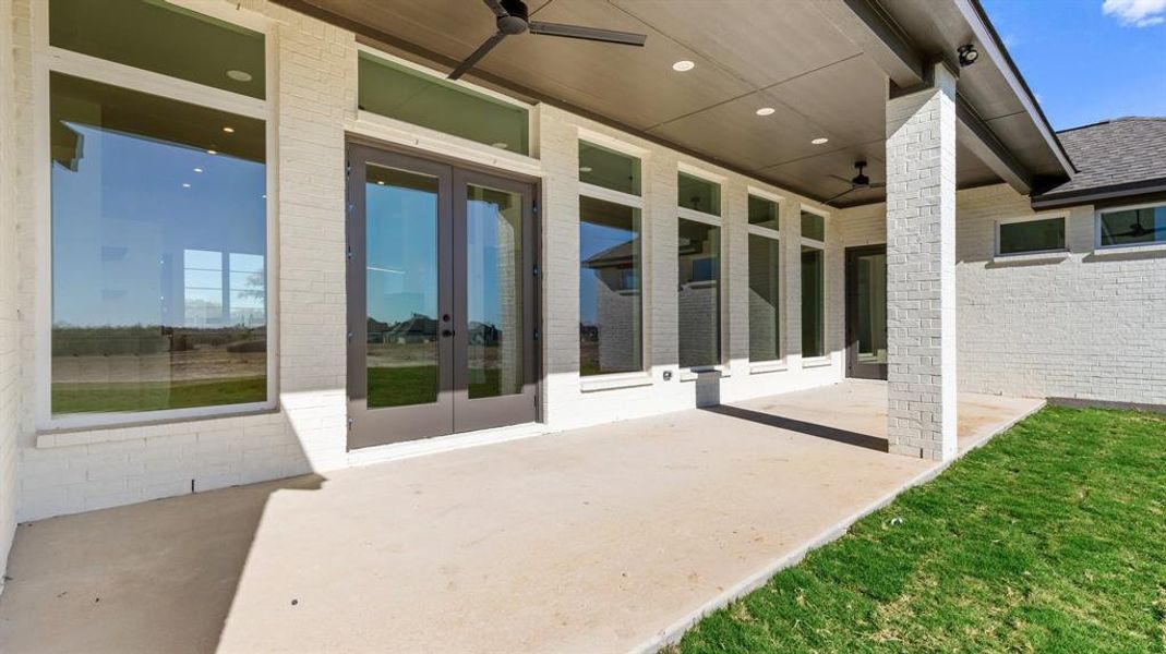 View of patio with french doors and ceiling fan