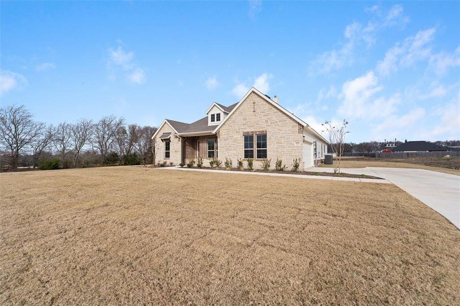 Front exterior of a new home in Nash Estates, Tom Bean, TX, highlighting curb appeal (Image 25). Front exterior of a new home in Nash Estates, Tom Bean, TX, highlighting curb appeal (Image 25).