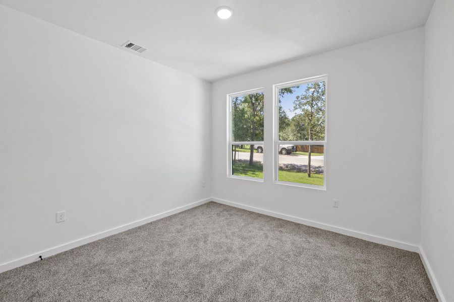 Ample natural light illuminates this tranquil bedroom with soft, new carpeting. Ample natural light illuminates this tranquil bedroom with soft, new carpeting.