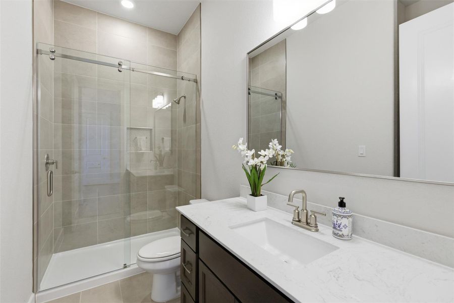 Full bathroom with vanity, a shower stall, and light tile patterned flooring