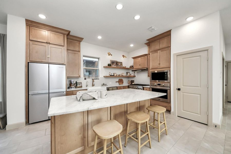 Unique features: spacious island, warm wood cabinetry with custom knobs and soft close cabinets.
