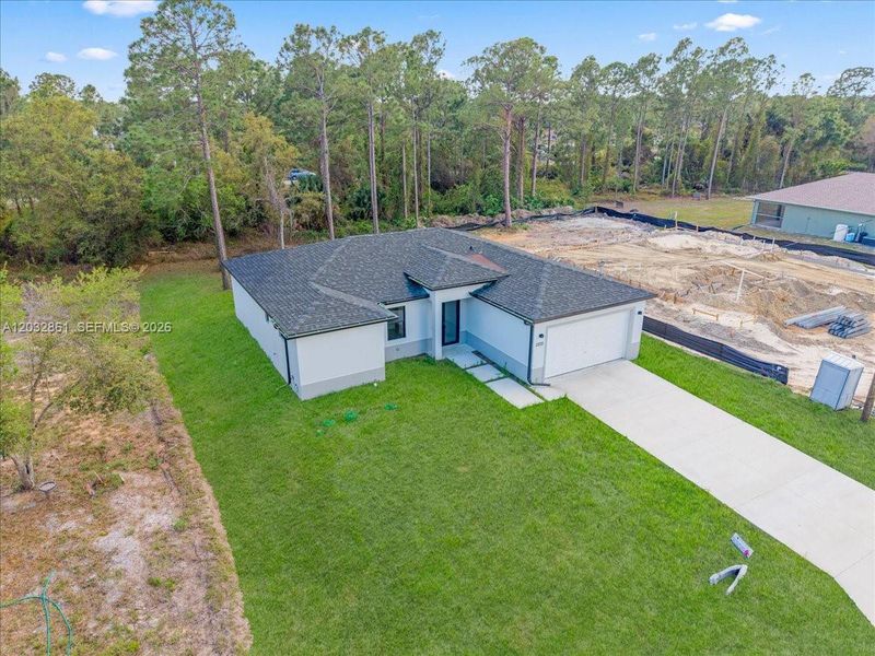 Front exterior of a new home in , Lehigh Acres, FL, highlighting curb appeal (Image 2). Front exterior of a new home in , Lehigh Acres, FL, highlighting curb appeal (Image 2).