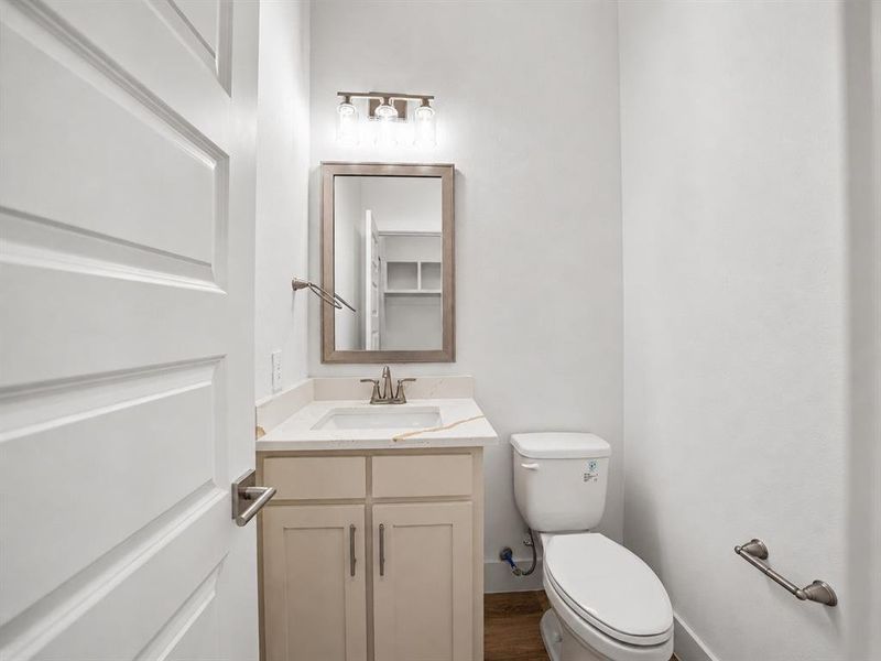 Bathroom featuring a vanity with an undermount sink, countertop, and a framed mirror