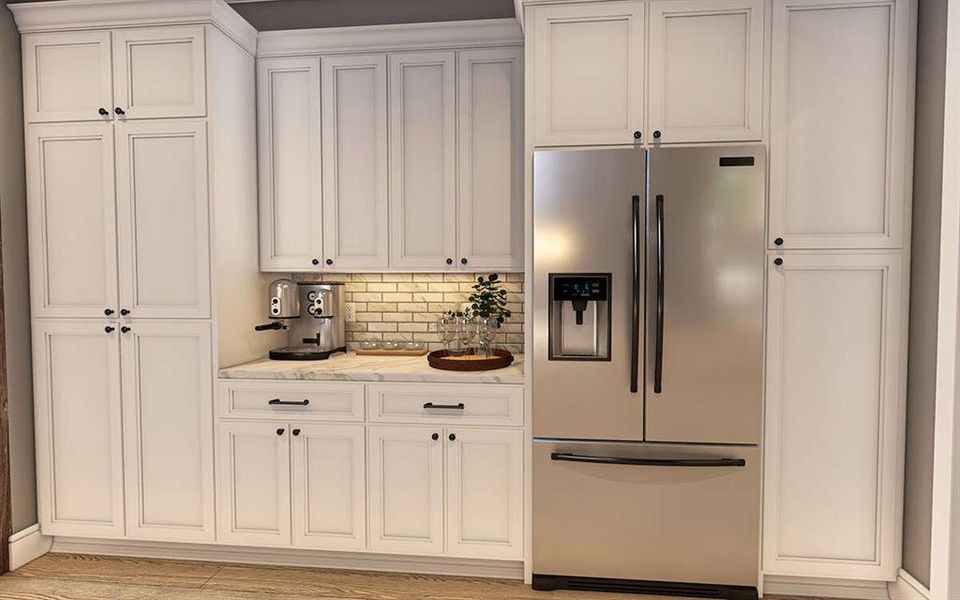 Kitchen with stainless steel fridge, light stone counters, decorative backsplash, and white cabinetry Kitchen with stainless steel fridge, light stone counters, decorative backsplash, and white cabinetry
