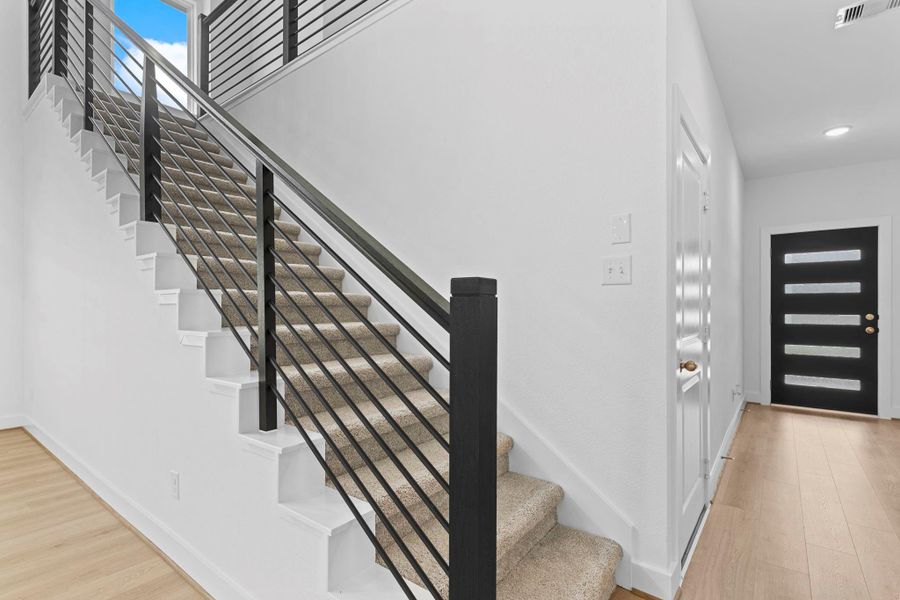 Contemporary wrought iron rails add a touch of elegance and architectural interest to the staircase, contrasting beautifully with the crisp white walls and soft carpeted steps. What a home to call home! **Image Representative of Plan Only and May Vary as Built**. Contemporary wrought iron rails add a touch of elegance and architectural interest to the staircase, contrasting beautifully with the crisp white walls and soft carpeted steps. What a home to call home! **Image Representative of Plan Only and May Vary as Built**.