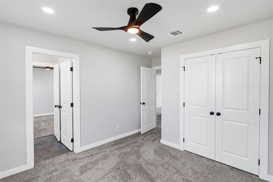 Unfurnished bedroom featuring carpet floors, baseboards, recessed lighting, and a closet