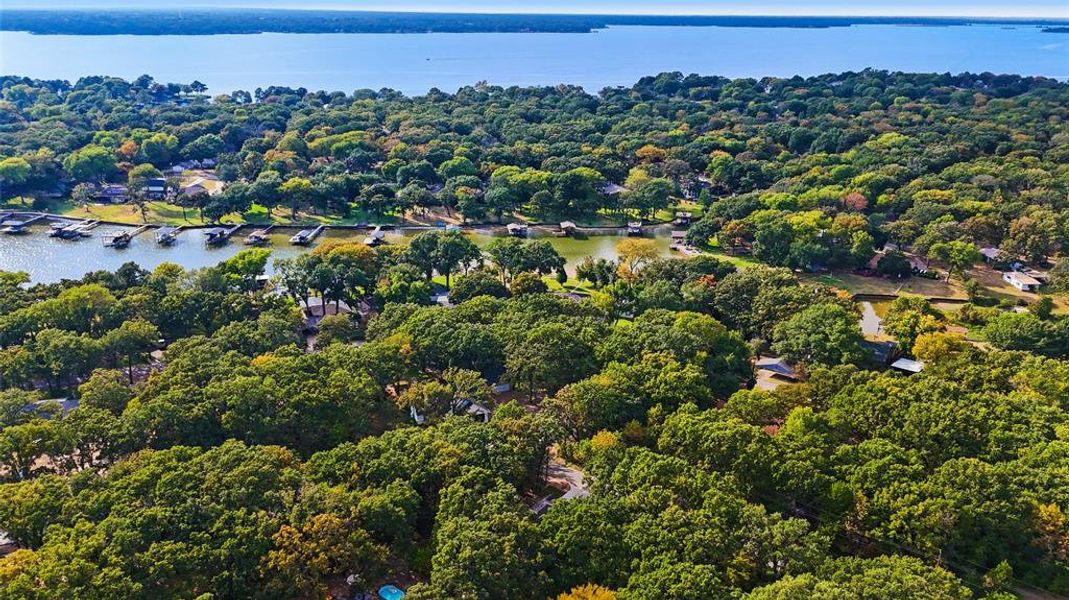 Aerial view of property and surrounding area featuring a heavily wooded area