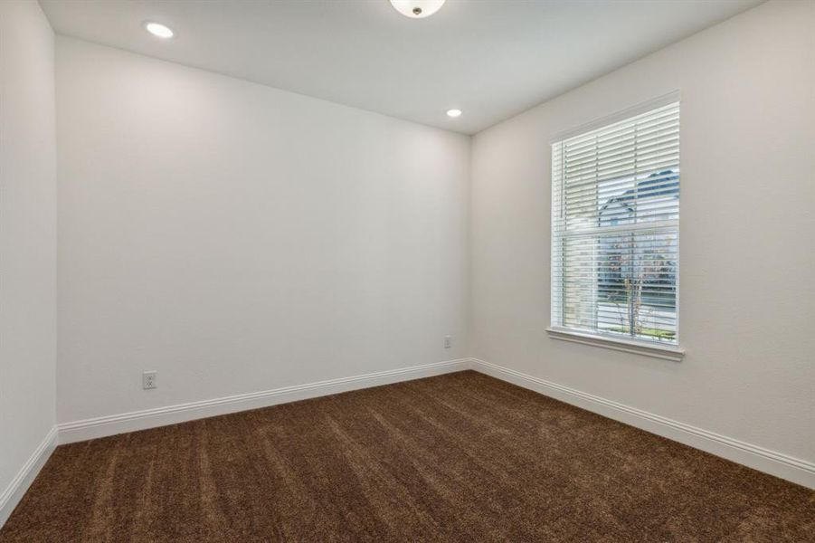 Carpeted spare room featuring plenty of natural light