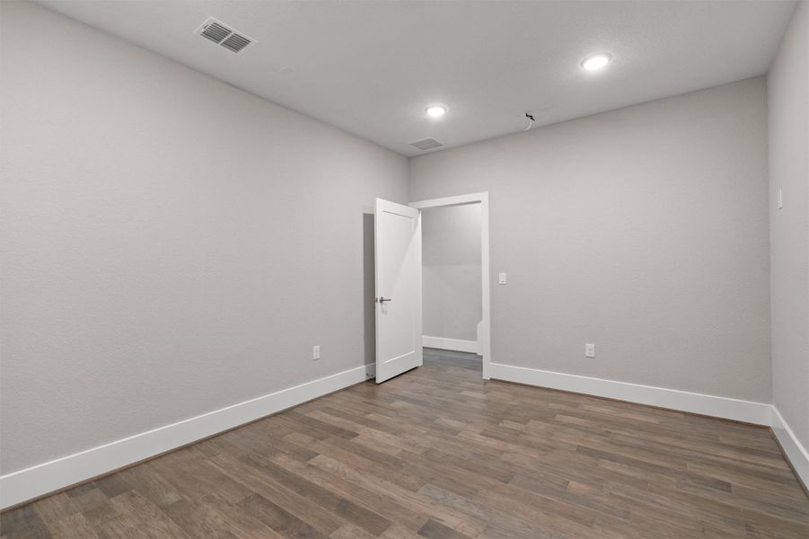 Recessed lighting illuminates wood-look flooring, creating a versatile, well-appointed interior space. Recessed lighting illuminates wood-look flooring, creating a versatile, well-appointed interior space.