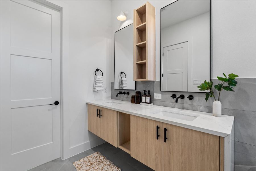 A sophisticated yet straightforward vanity wall combines integrated storage and wall-mounted fixtures, delivering a clean, efficient layout that emphasizes precision, usability, and modern craftsmanship.