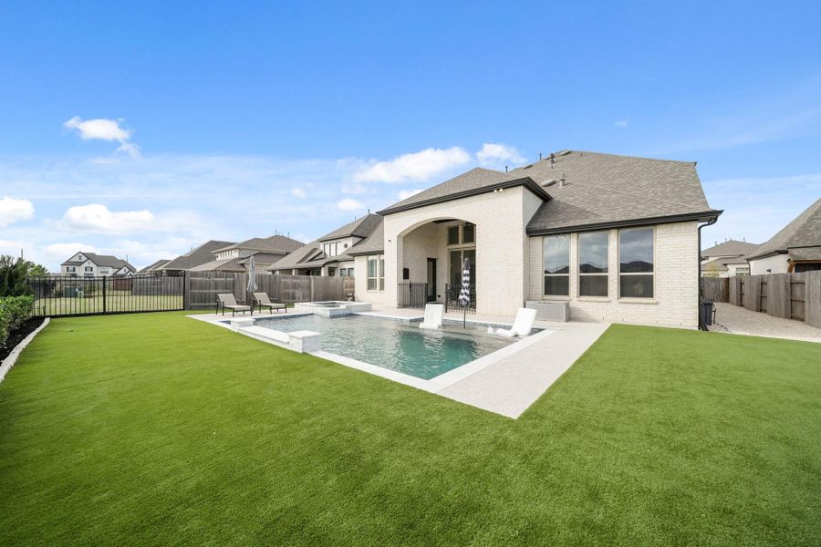 To the right is a 60’ x 10’ gravel sideyard offering a practical space that could serve as a dog run, with a gate providing direct access to the front yard.