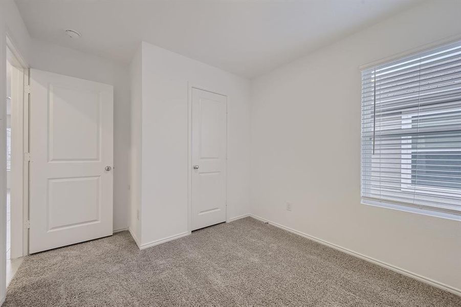 Carpeted secondary bedroom