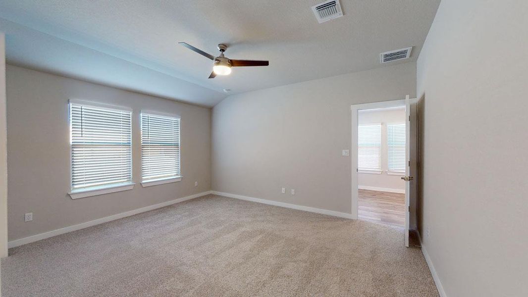 Comfortable carpeted space with ample natural light from two large windows, offering versatile living possibilities. Comfortable carpeted space with ample natural light from two large windows, offering versatile living possibilities.