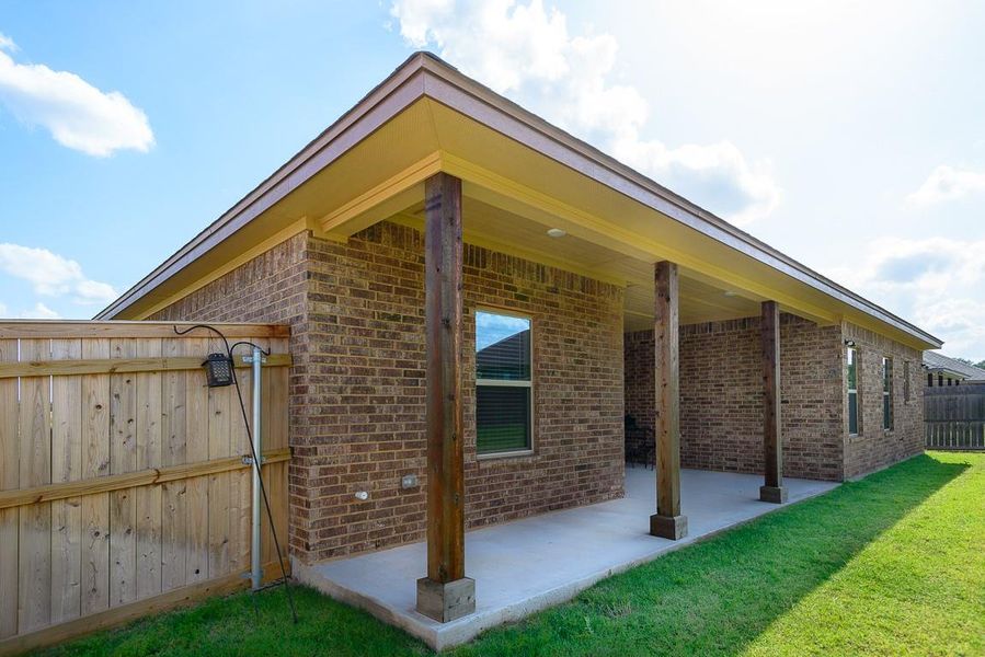 View of side of property with brick siding and a patio View of side of property with brick siding and a patio