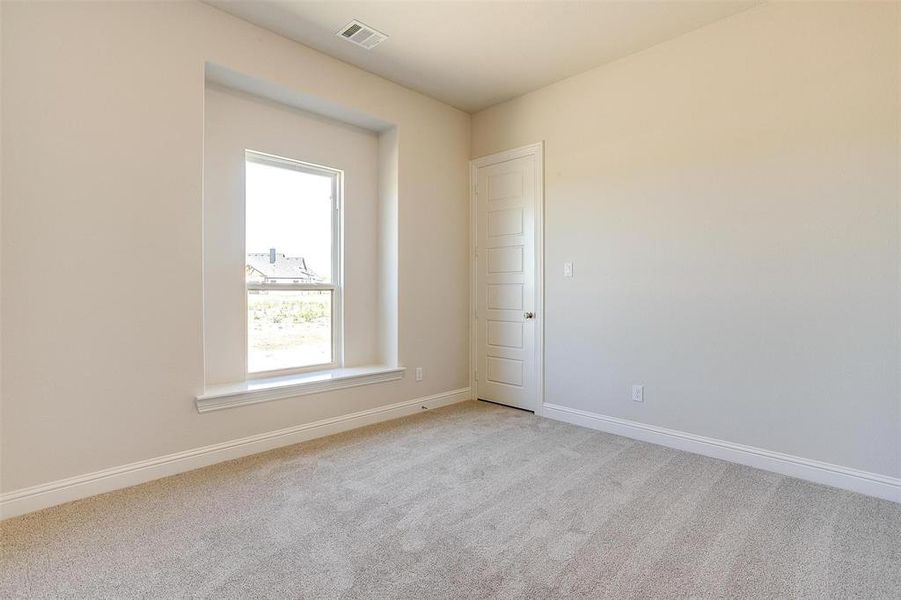 Spare room featuring light colored carpet