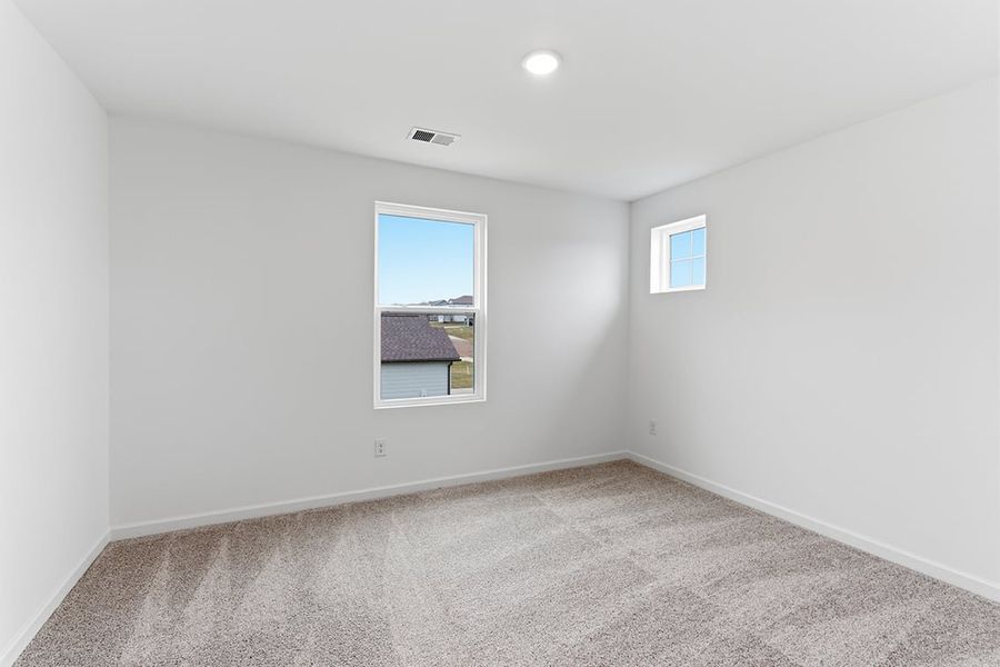 A room with a window and carpet.