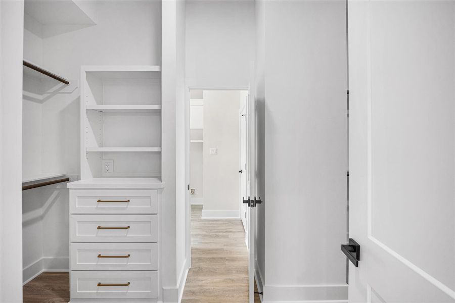His and Hers Primary Closet with Access to Laundry Room.
