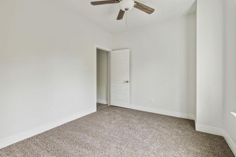 Empty room with ceiling fan and carpet