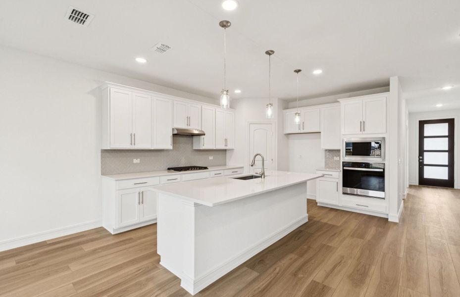 Kitchen featuring a large island ideal for informal dining and gatherings  *Real home pictured