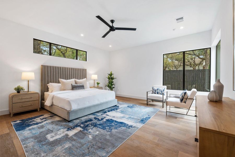 Bedroom with light wood finished floors, a ceiling fan, and recessed lighting
