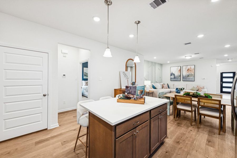 The Mockingbird II- Kitchen into Family Room. Sample image for illustration; upgrades, options, and colors may vary.