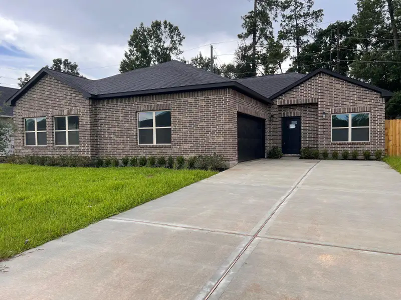 Front exterior of a new home in , Spring, TX, highlighting curb appeal (Image 1).