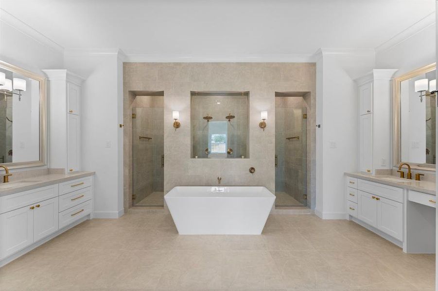 Experience the epitome of luxury in this stunning primary bathroom. This modern, spacious retreat features a beautifully designed freestanding bathtub, perfectly centered against a stylish tiled wall with elegant decorative niches.