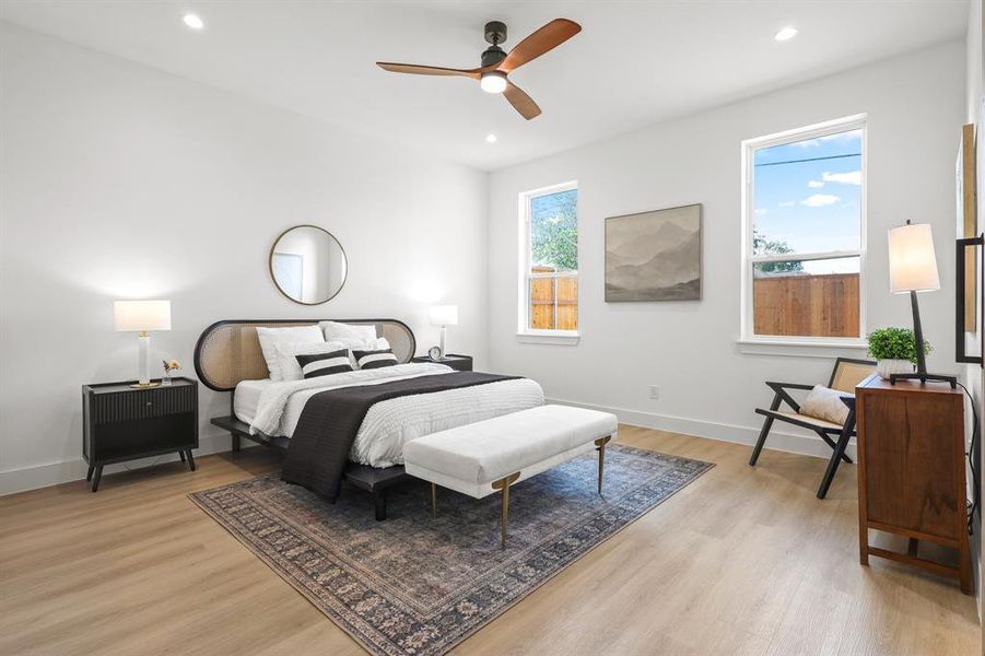 Bedroom with ceiling fan and light wood-type flooring