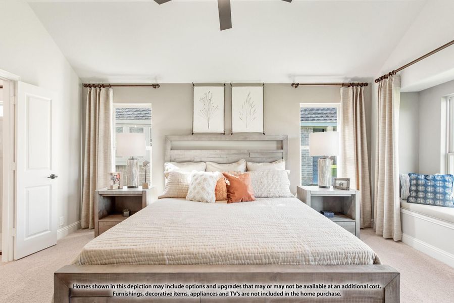 Master bedroom with king bed, ceiling fan, window seat, and two large windows with neutral drapes