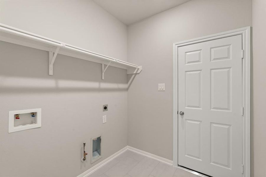 The laundry room layout is carefully planned for optimal workflow with designated areas for washing, drying, and storing.