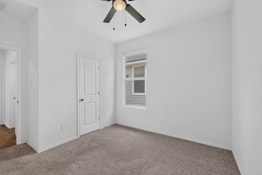 Soft carpeting pairs with neutral walls in this versatile room lit by a central window. Soft carpeting pairs with neutral walls in this versatile room lit by a central window.