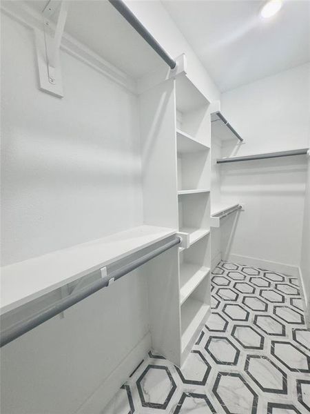 Walk in closet featuring light tile floors