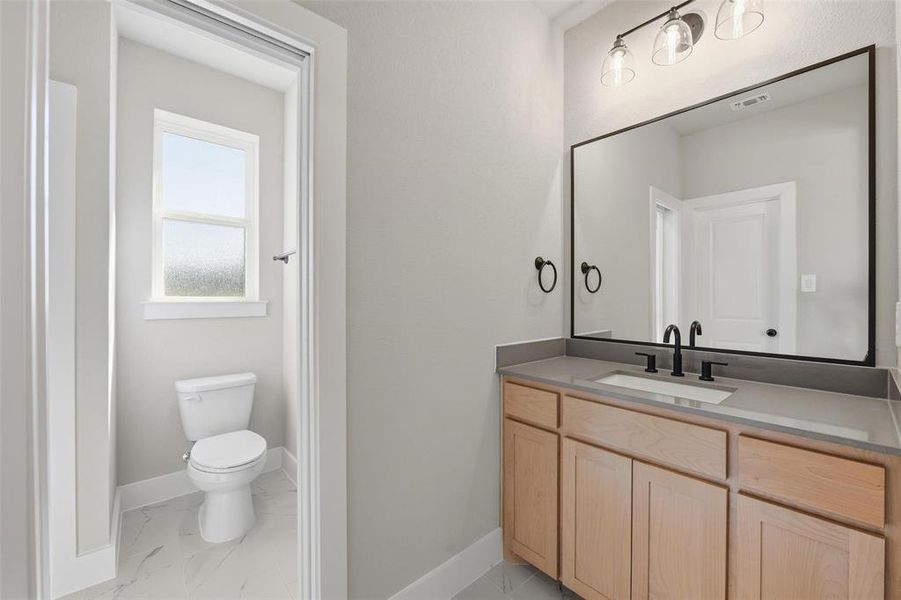 Bathroom featuring vanity and light marble finish floors