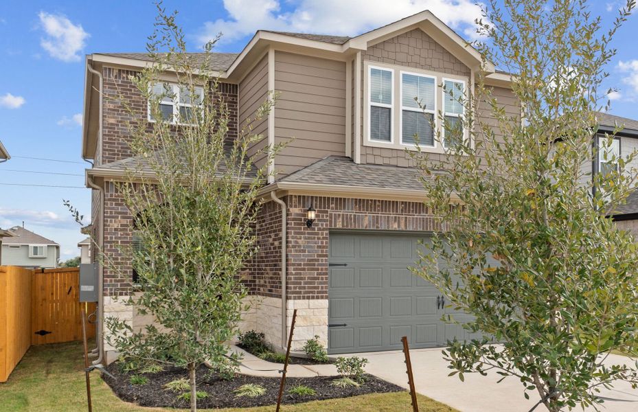 Front exterior of a new home in Crosswinds, Kyle, TX, highlighting curb appeal (Image 6). Front exterior of a new home in Crosswinds, Kyle, TX, highlighting curb appeal (Image 6).