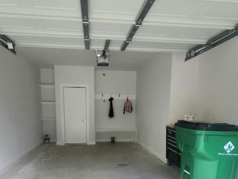 Garage featuring a garage door opener